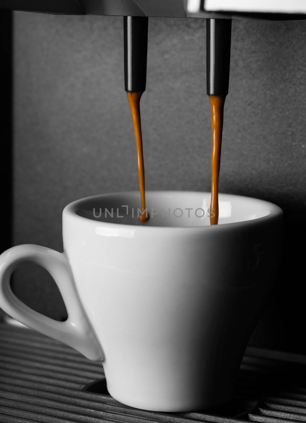 of espresso machine hot drink poured into into a cup