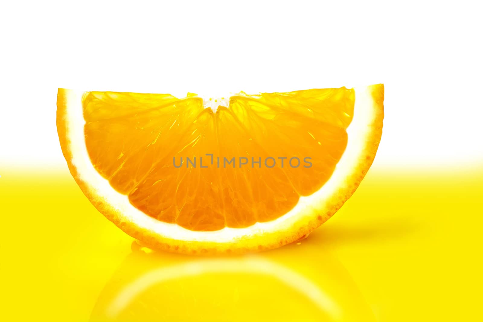 ripe orange slice close-up lying in the yellow juice