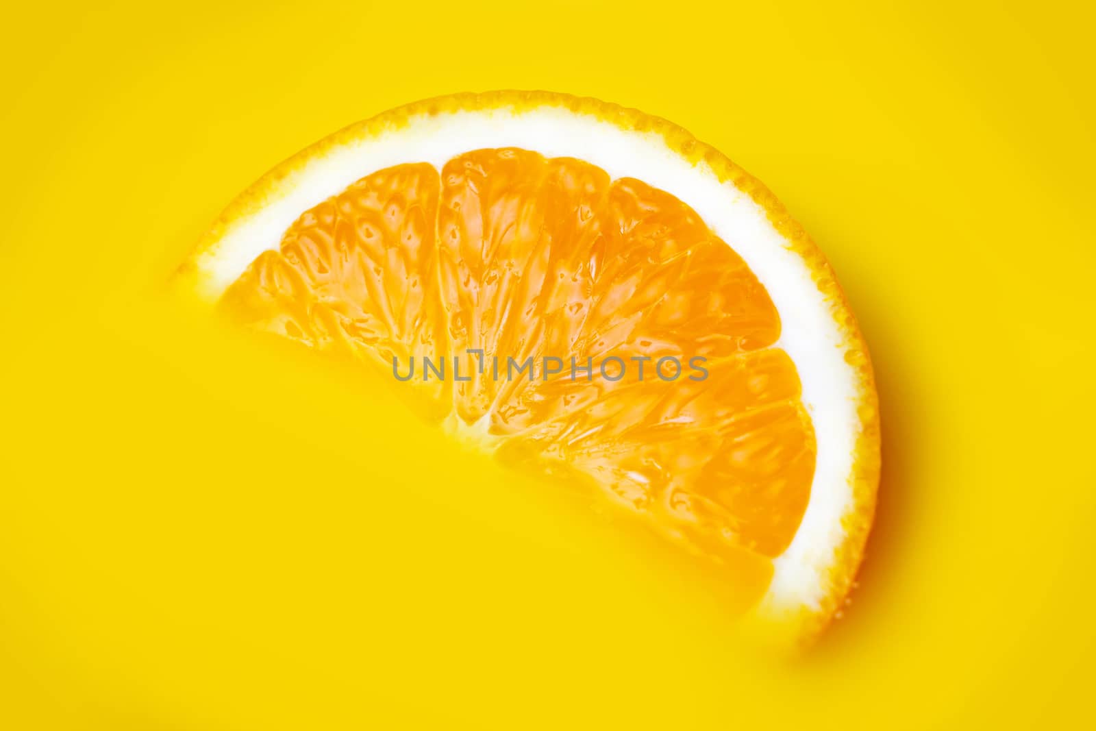 fresh a slice of orange on yellow background
