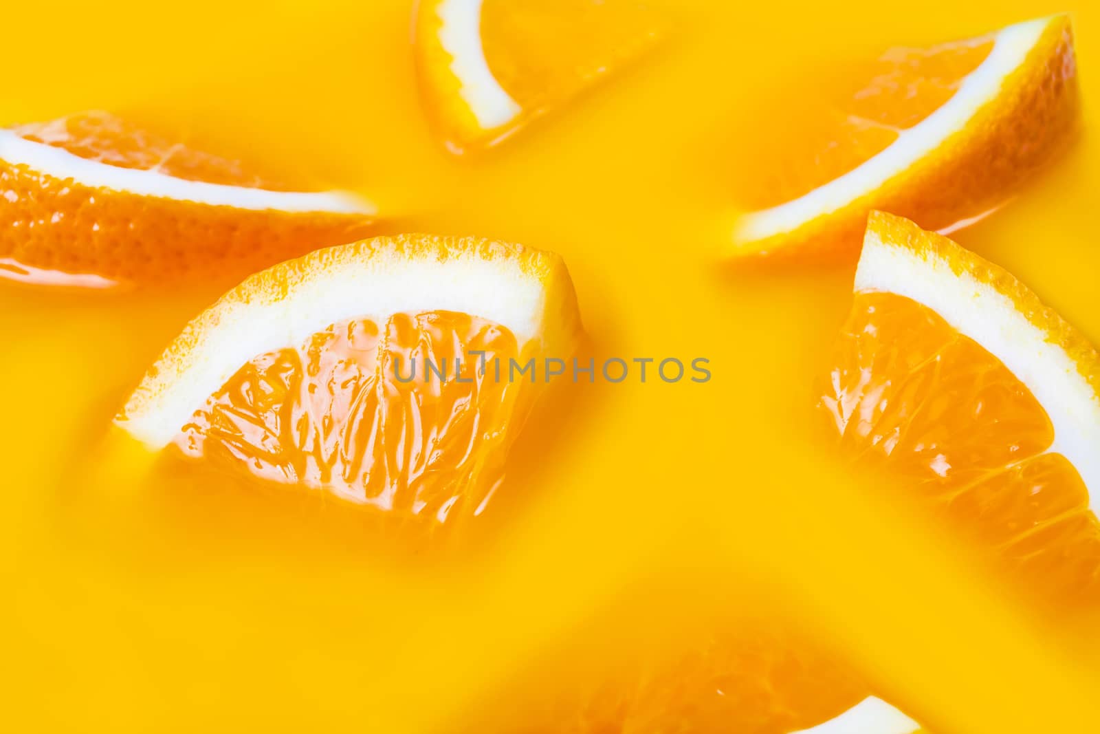 Many fresh a slice of orange close-up on yellow background
