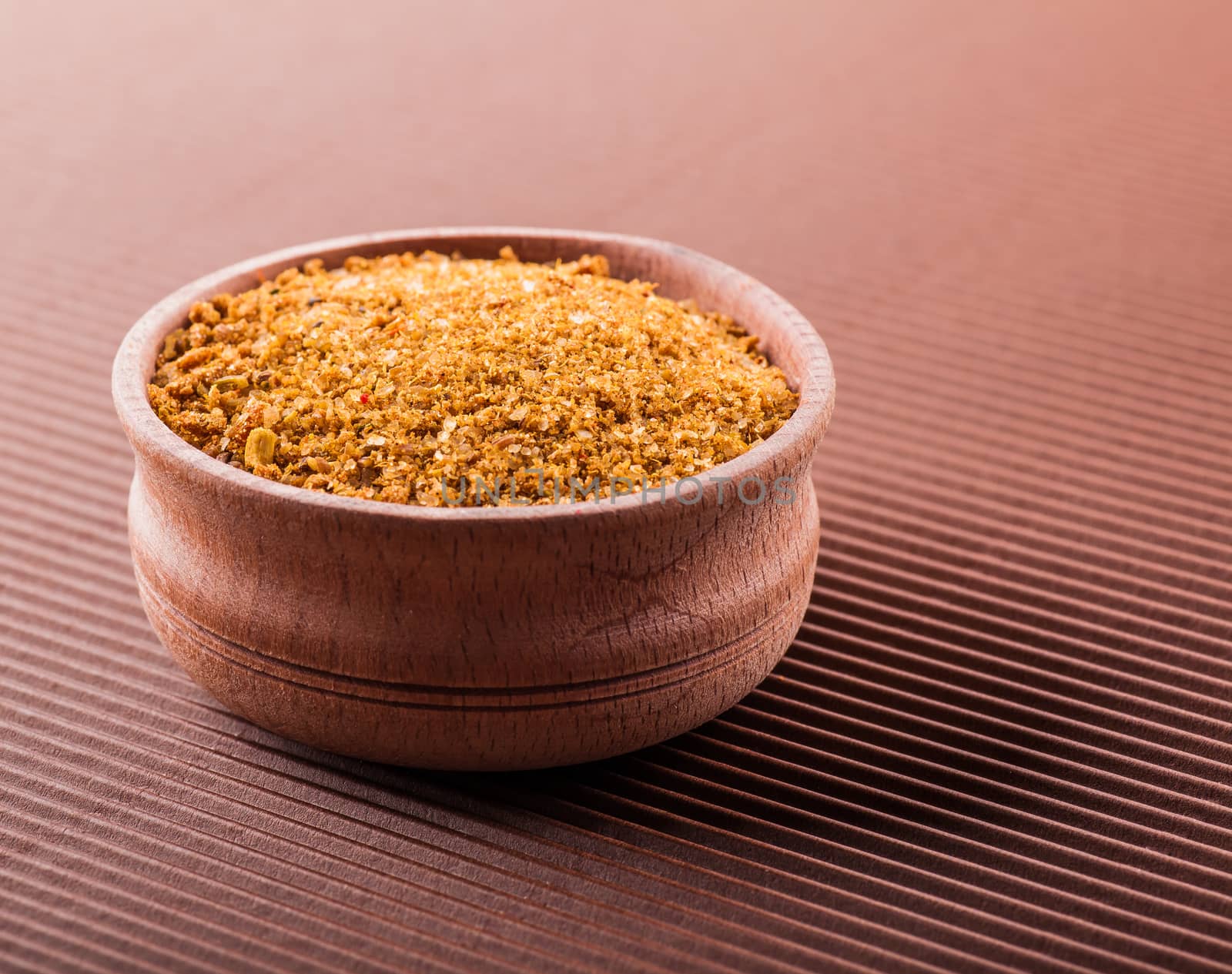 savoy salt in a wooden bowl on a brown background
