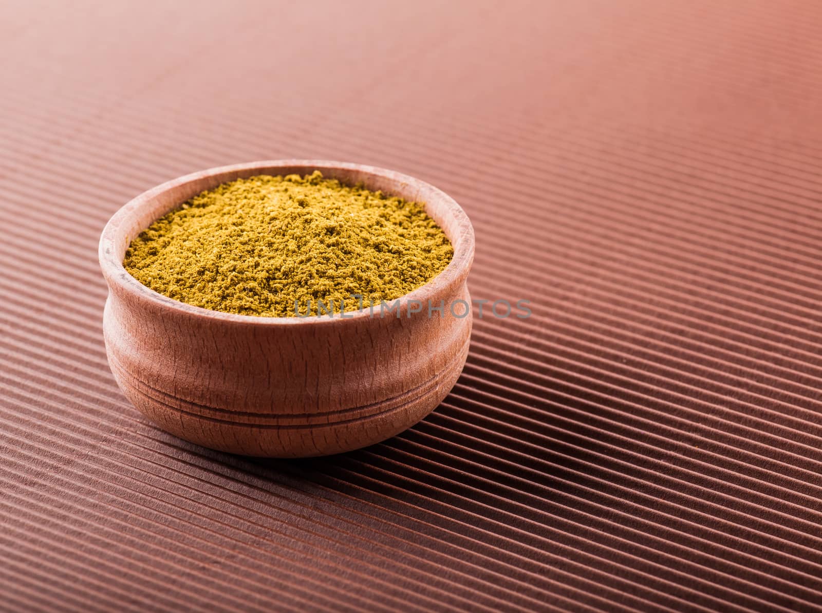 hops-suneli in a wooden bowl on a brown background