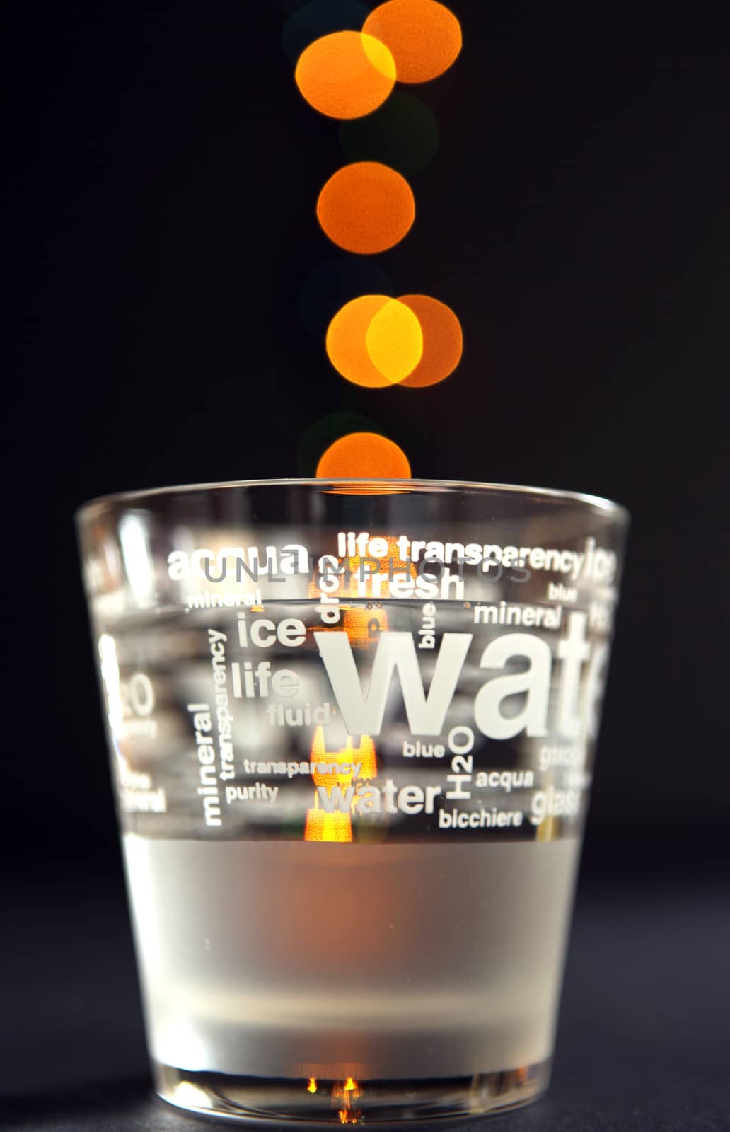 glass of water on a black background with lights