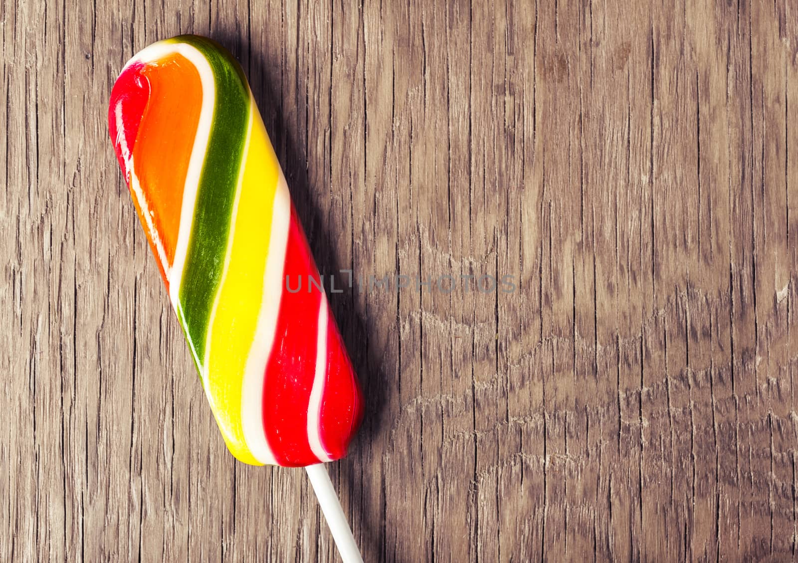 colorful sweet lollipop on a wooden background