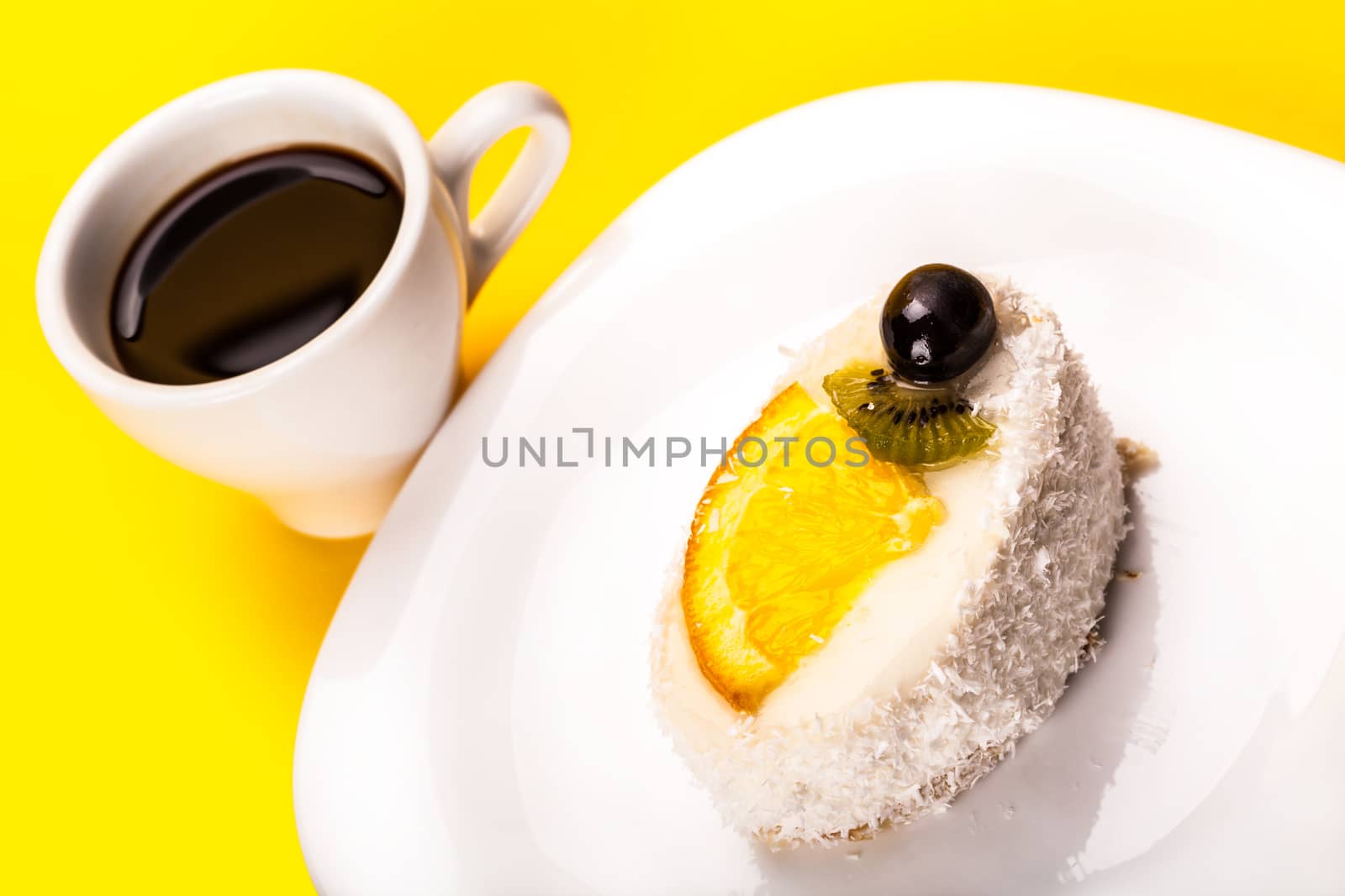 coconut piece of cake and coffee on a yellow background