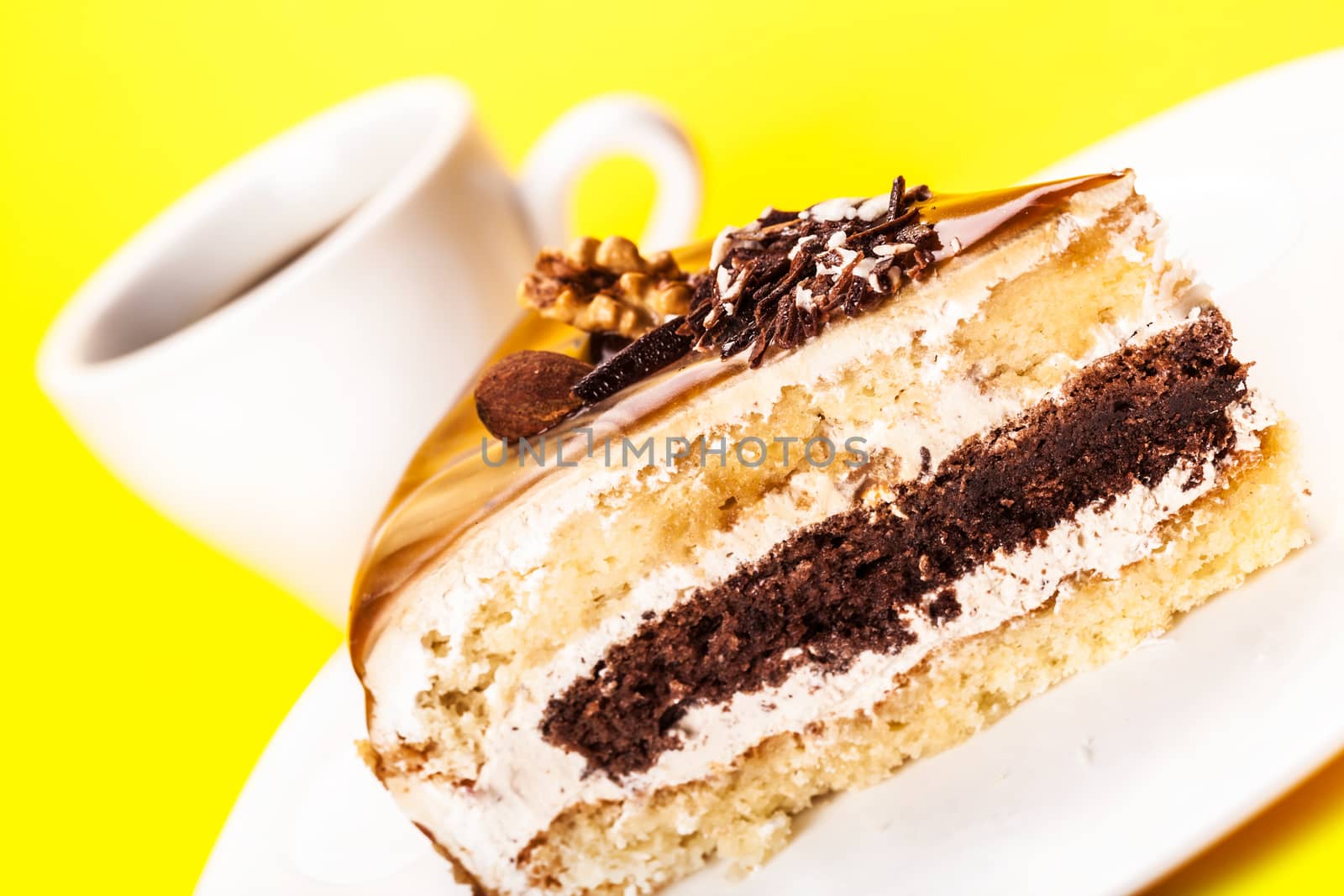 piece of cake and a cup of coffee on a yellow background
