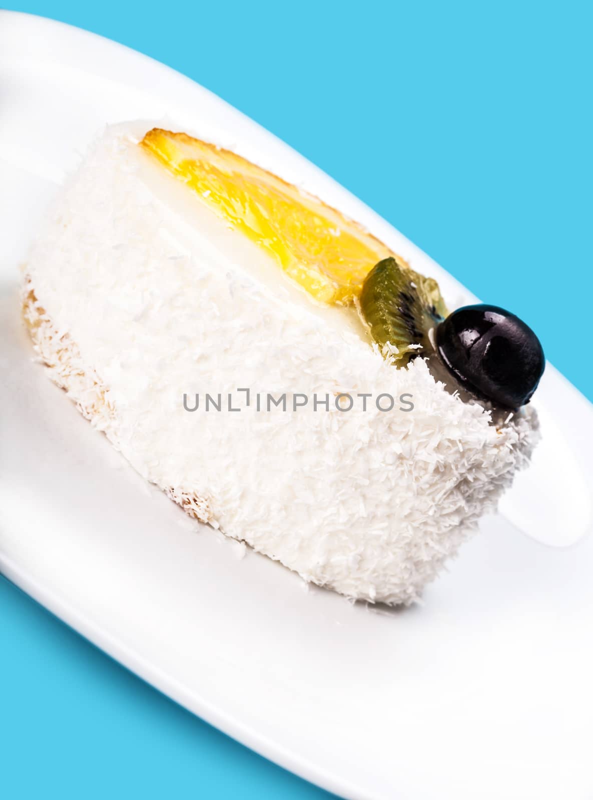 coconut slice of cake closeup on blue background
