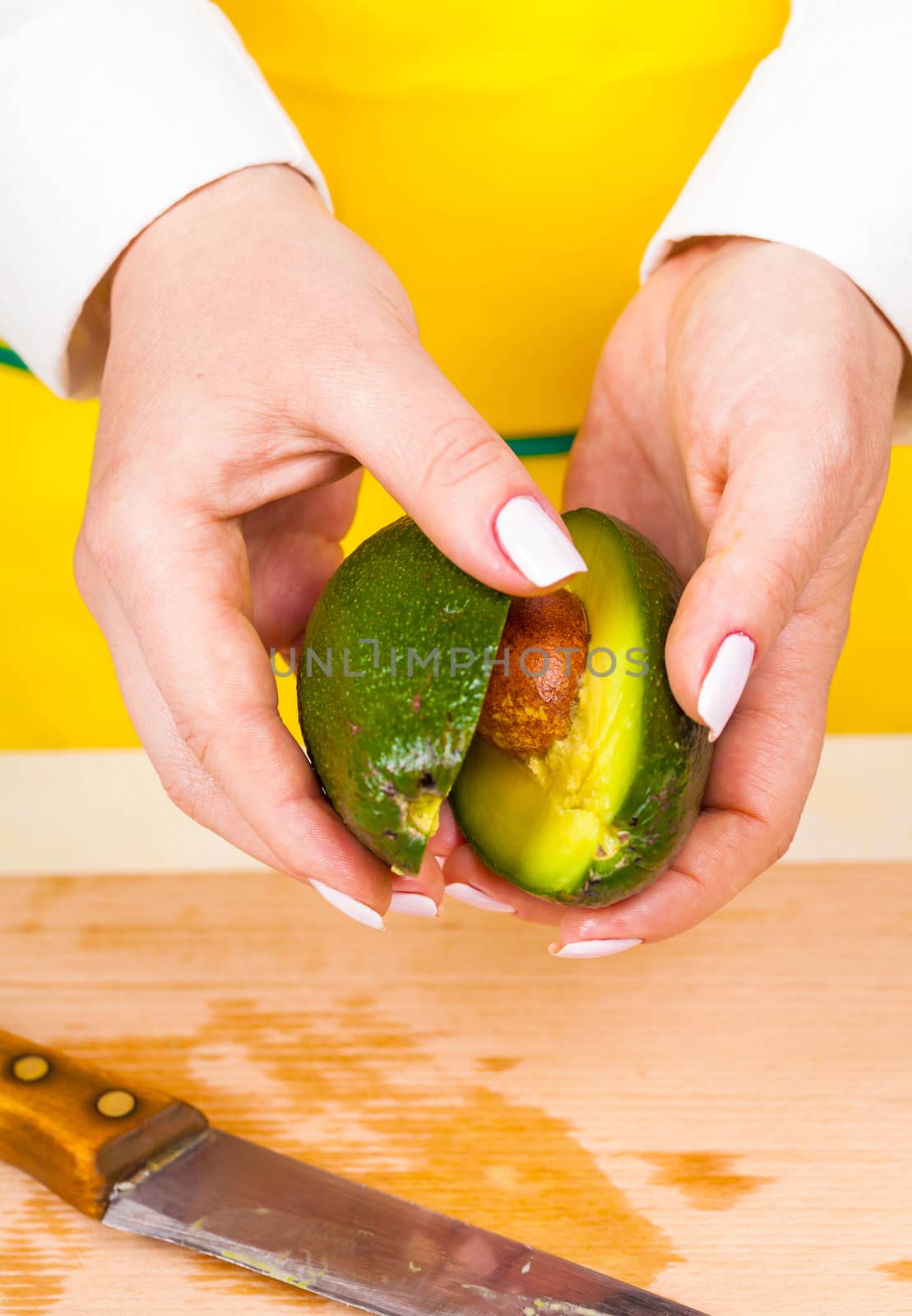 separates avocado into two parts  by MegaArt