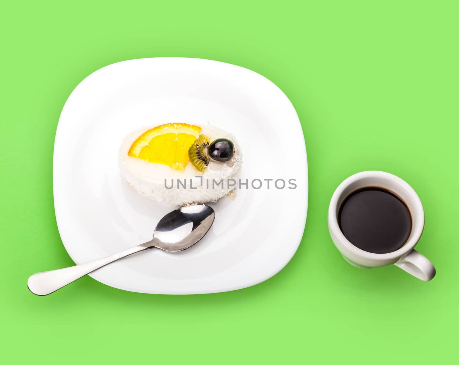 coconut piece of cake and coffee cup on a green background