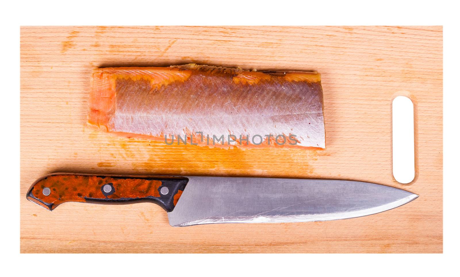 red fish fillet and knife on a wooden board