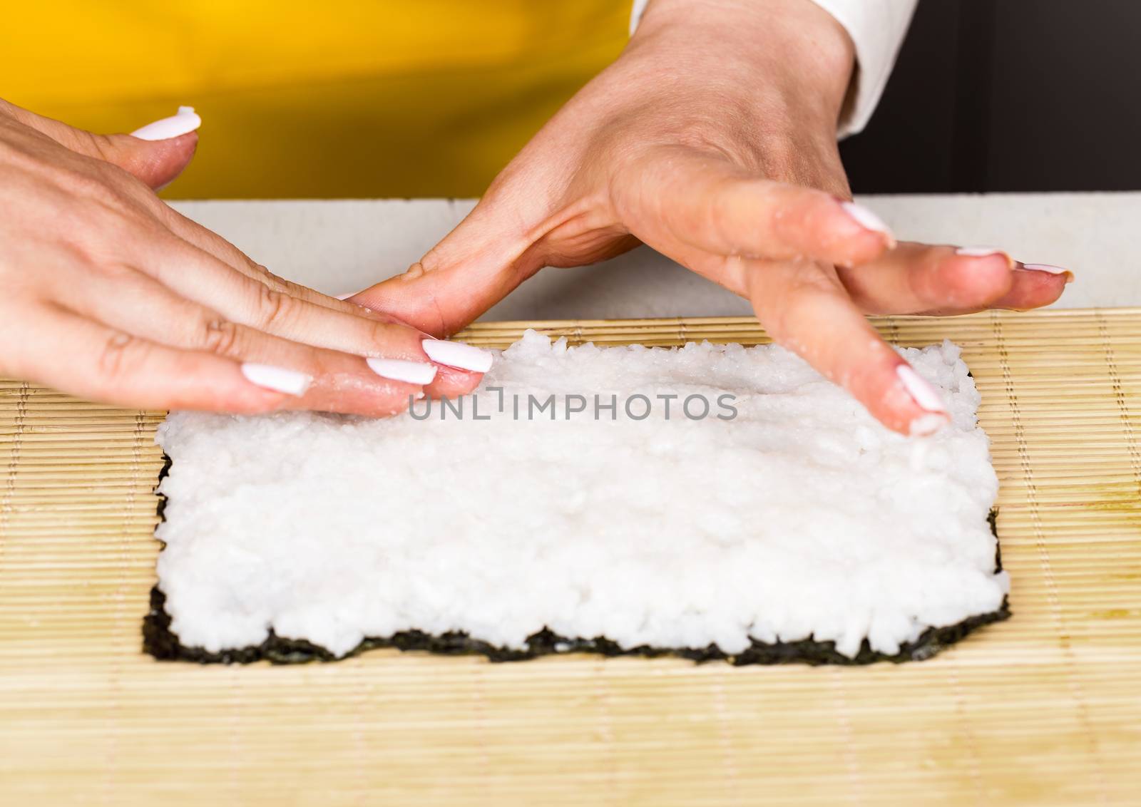 chef places the rice on the nori sheet