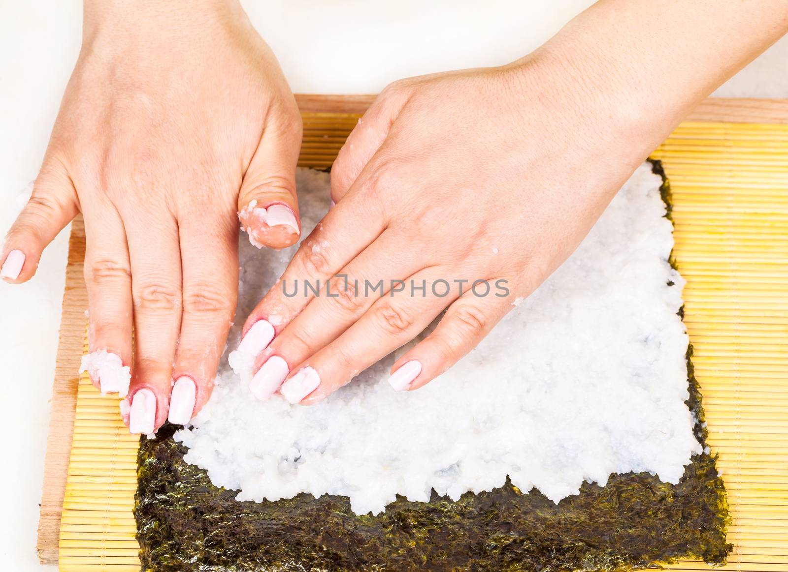 chef places the rice on the nori sheet