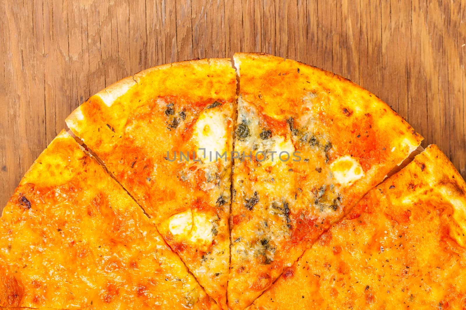 hot pizza four cheese on a wooden background