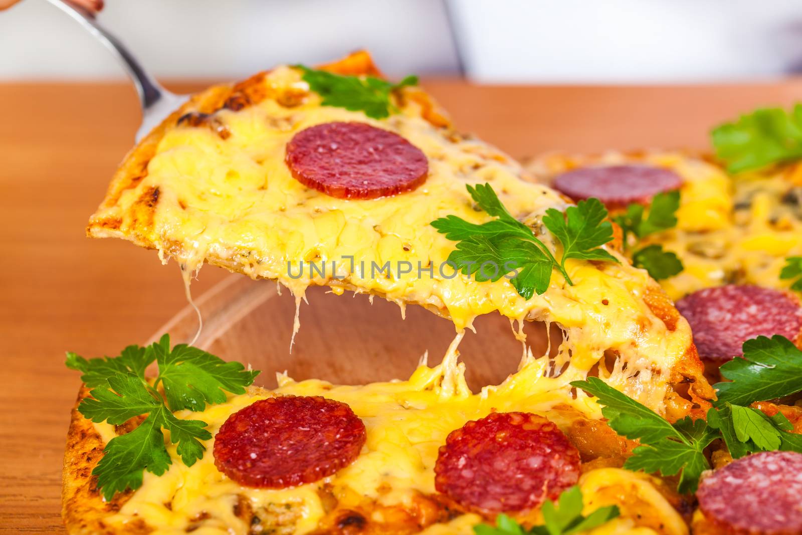 pizza with salami closeup on wooden background