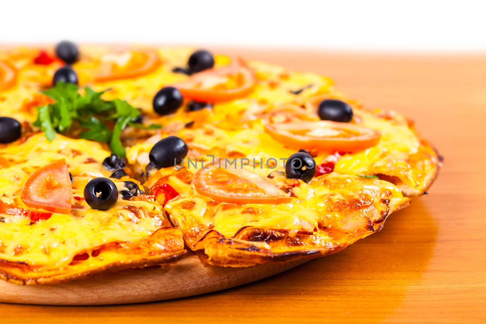hot fresh pizza with olives closeup on wooden background