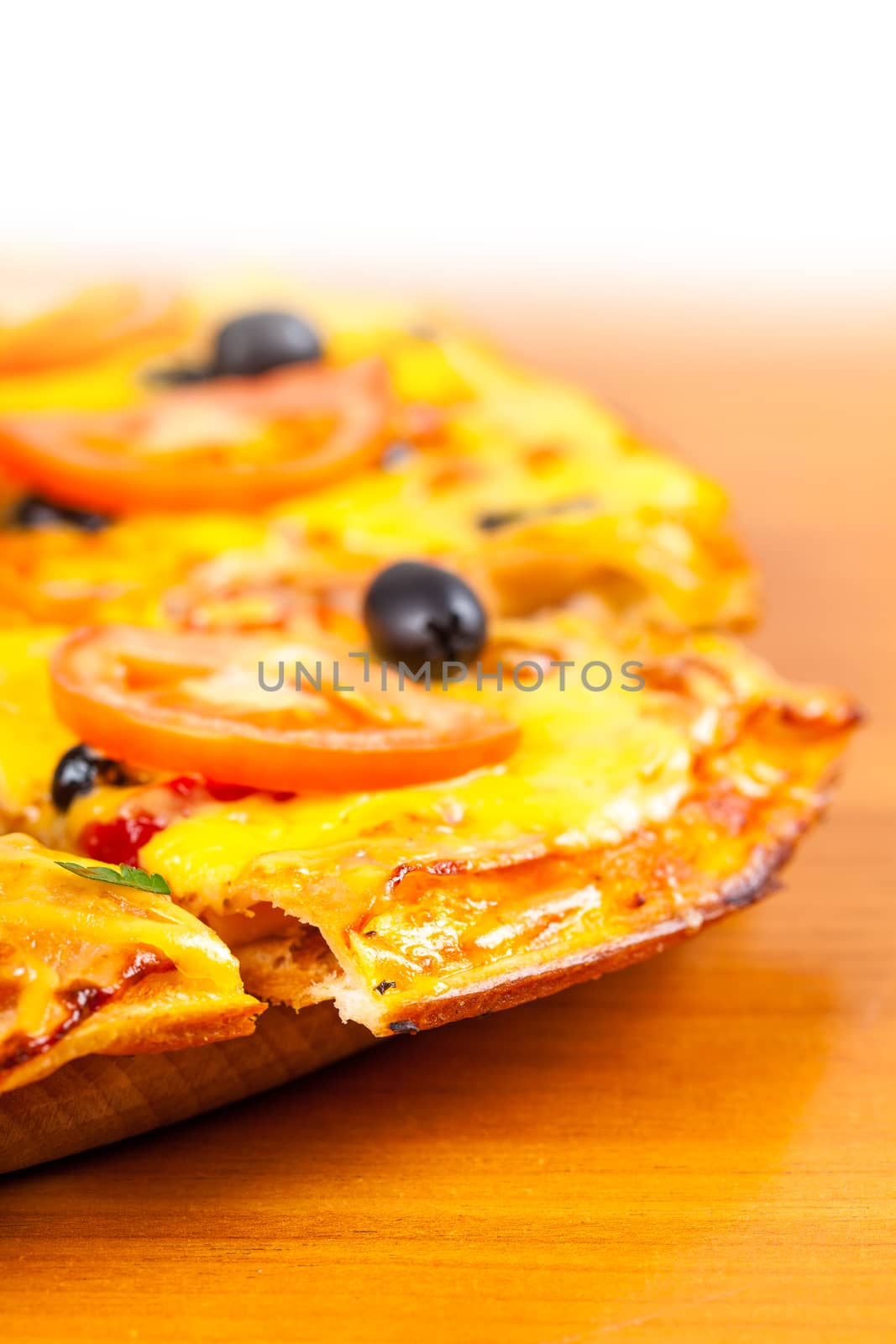 hot fresh pizza closeup on wooden background