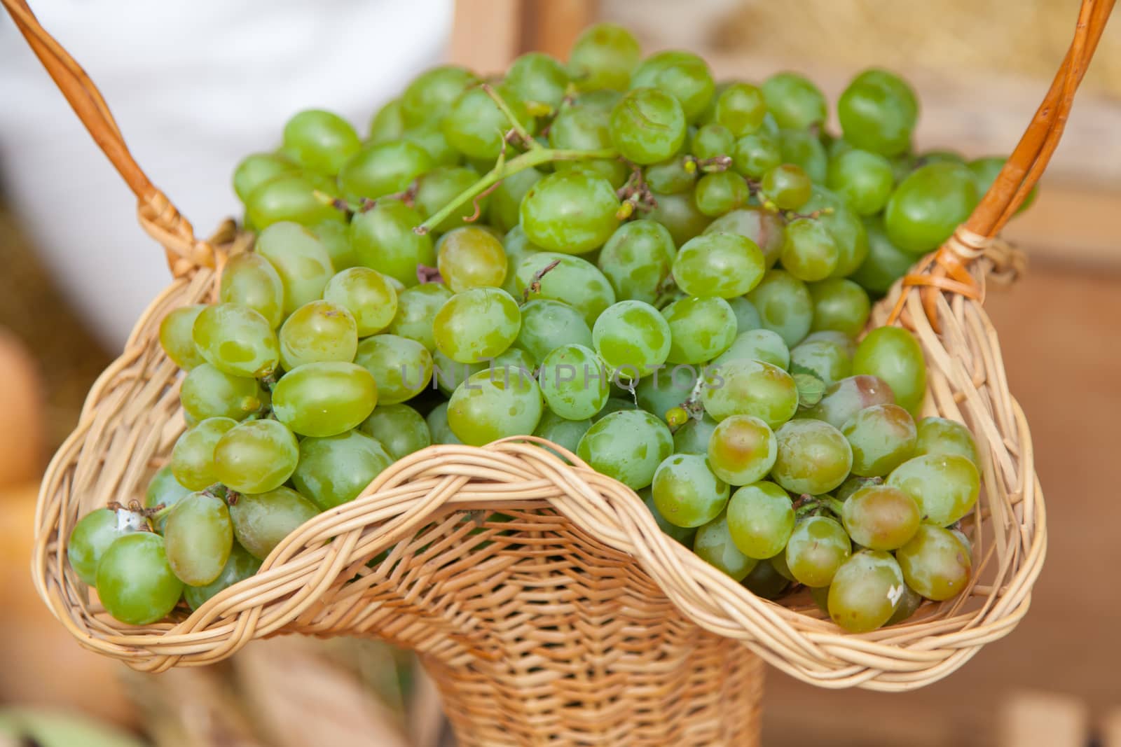 Fresh bunch of green grapes in a basket