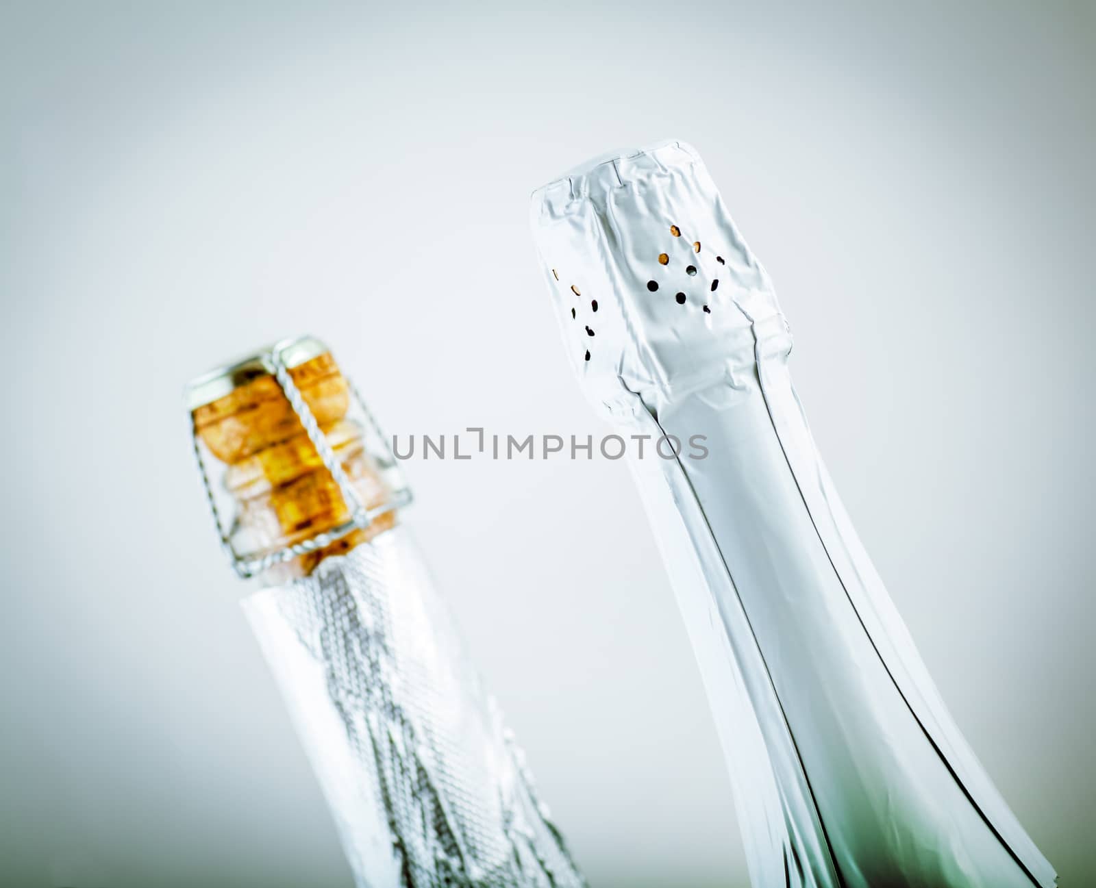 two neck of a bottle of champagne closed
