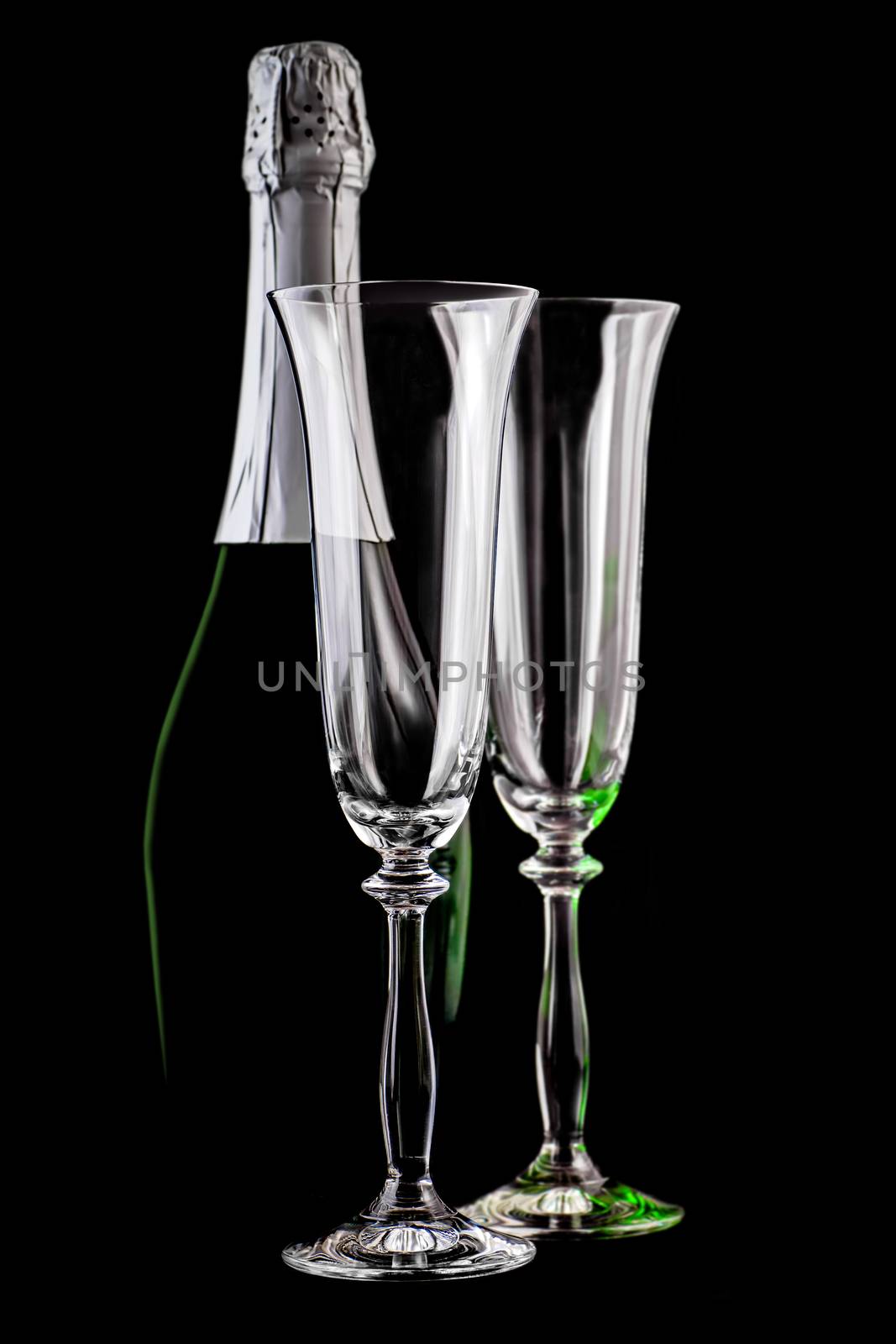bottle of champagne and empty glasses on a dark background