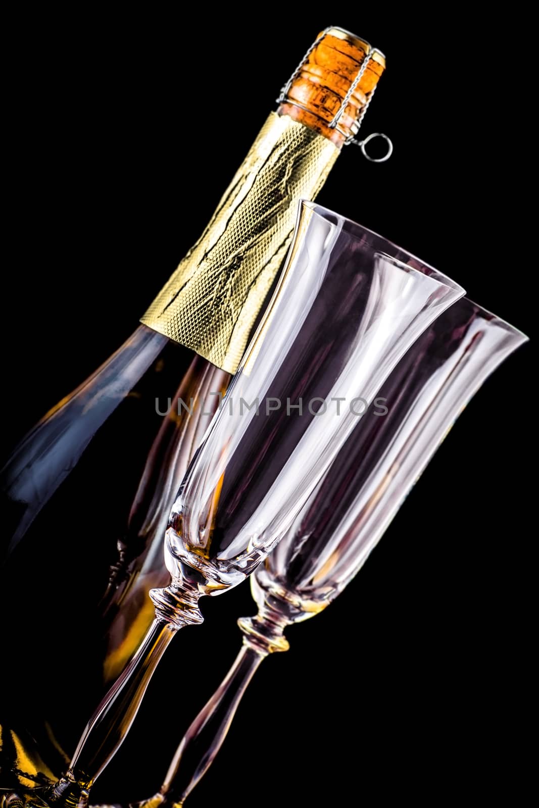 bottle of champagne and two glasses on a dark background