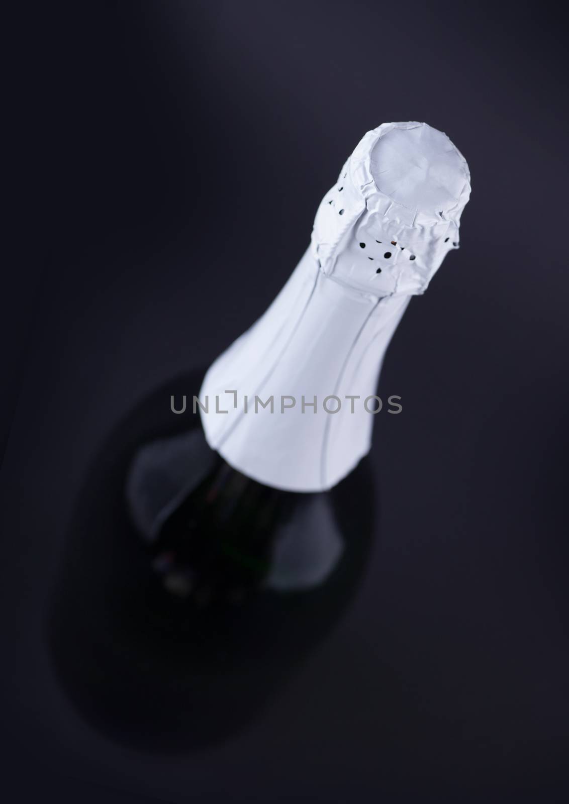 a bottle of sparkling champagne on a dark background