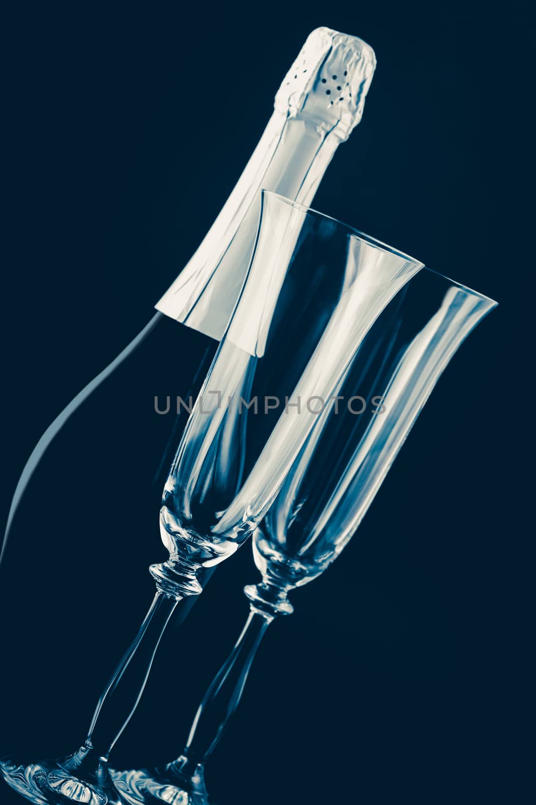 bottle of champagne and glasses on a dark background