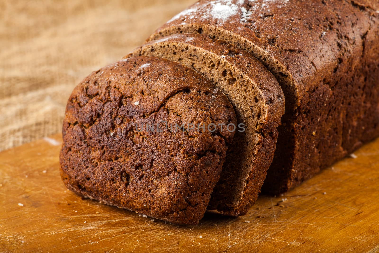 sliced rye bread on a wooden background