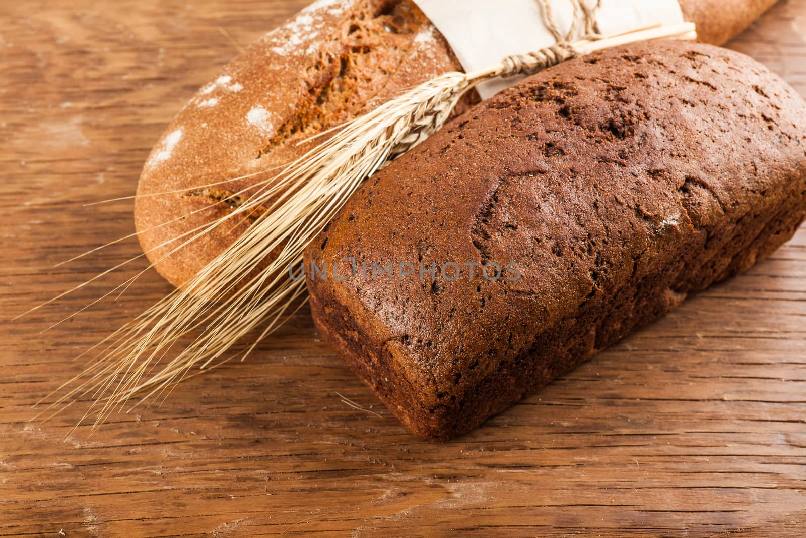 two black bread on a wooden background