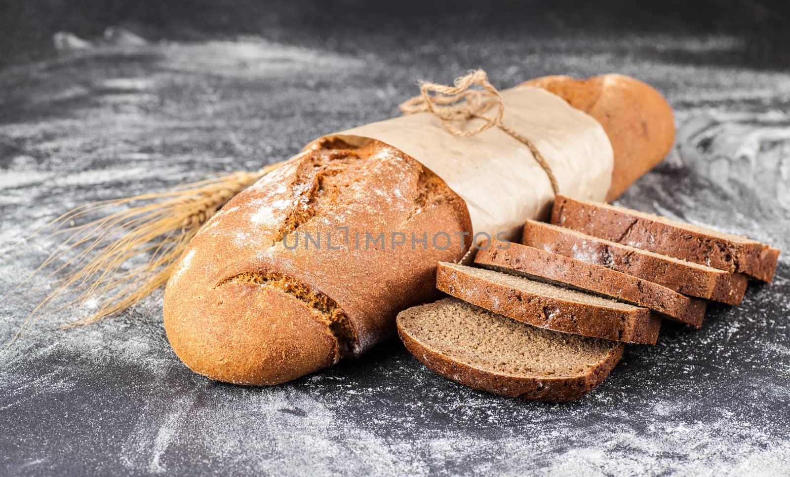  sliced bread on a dark background with flour