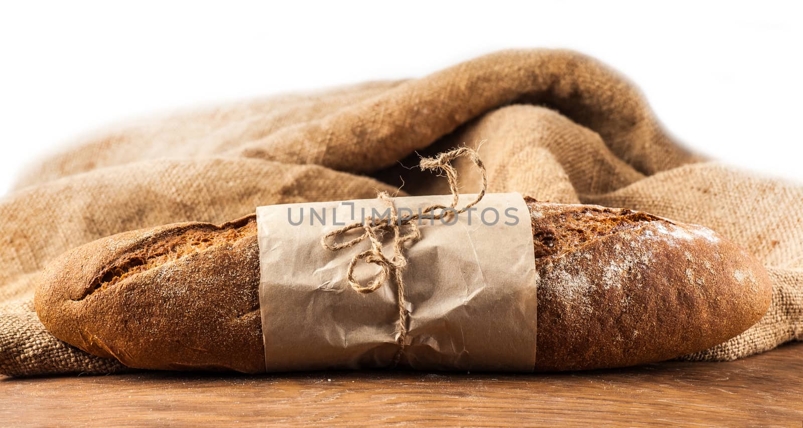 a loaf of black bread on a wooden board