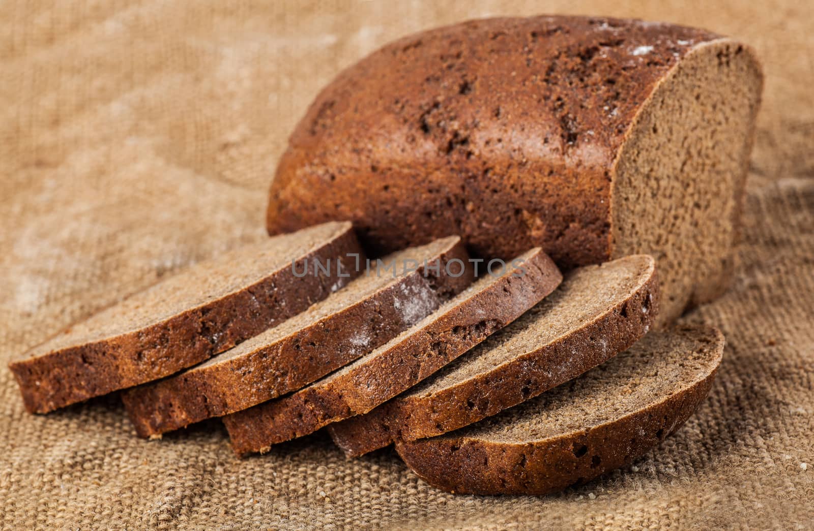 sliced loaf rye bread on old cloth