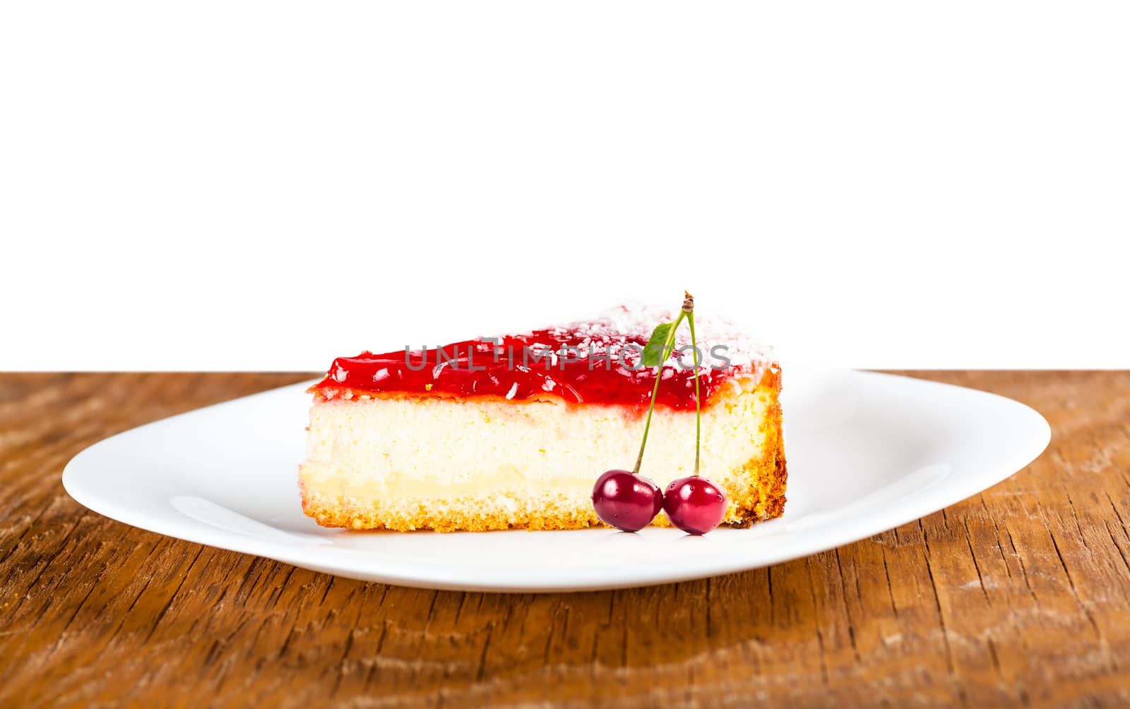 a piece of fruit cheesecake on a white plate with cherries