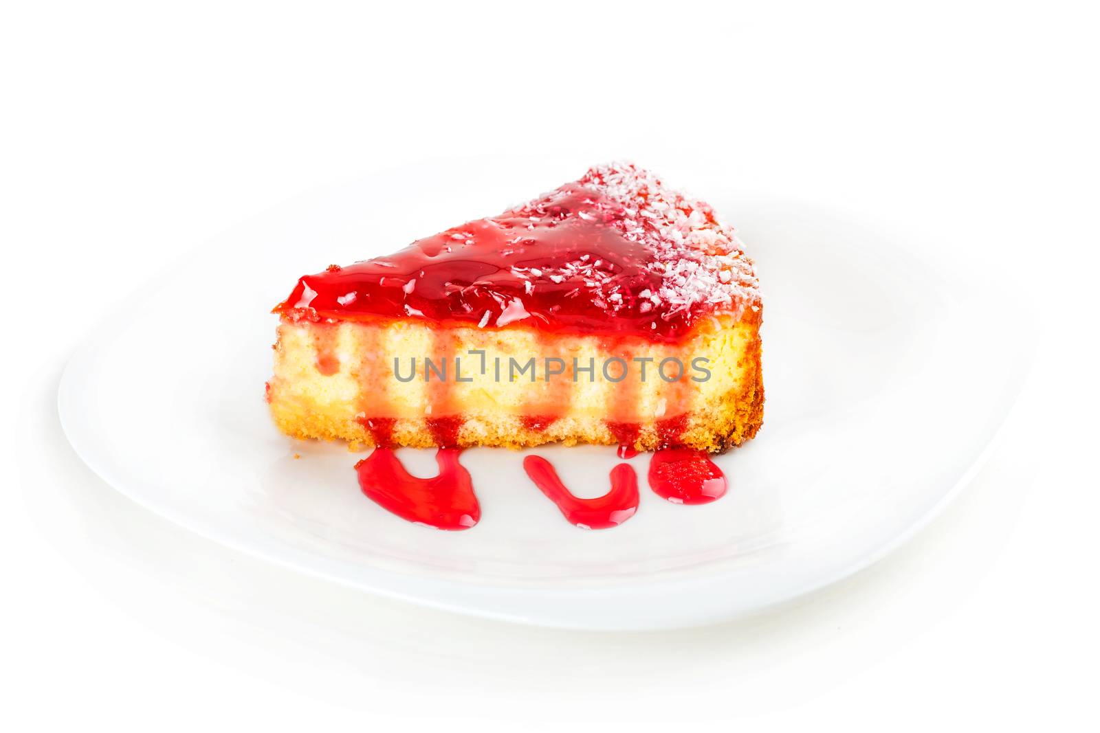 a piece of fruit cream cake on a white plate with jam