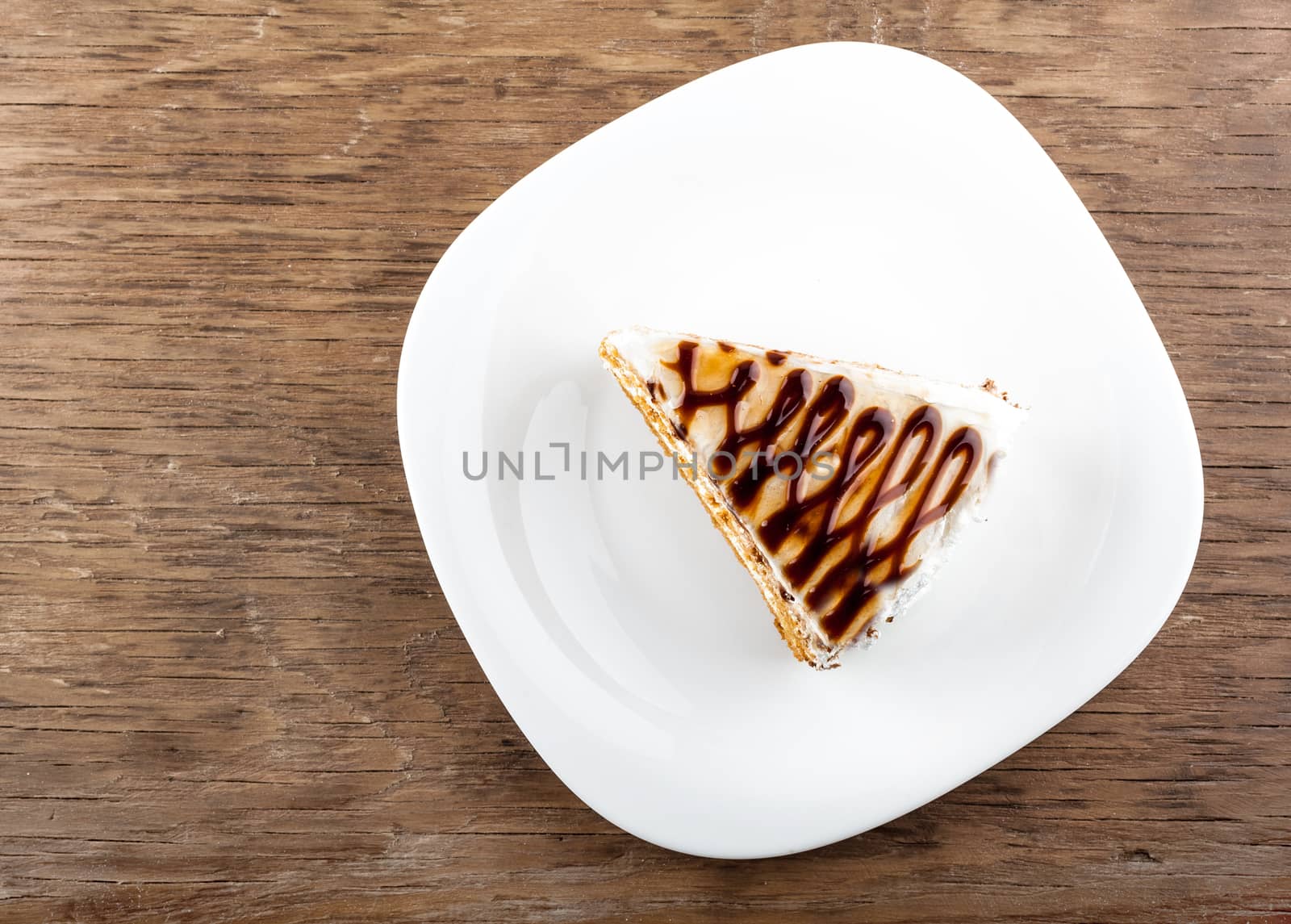 chocolate cake on a plate on a wooden background