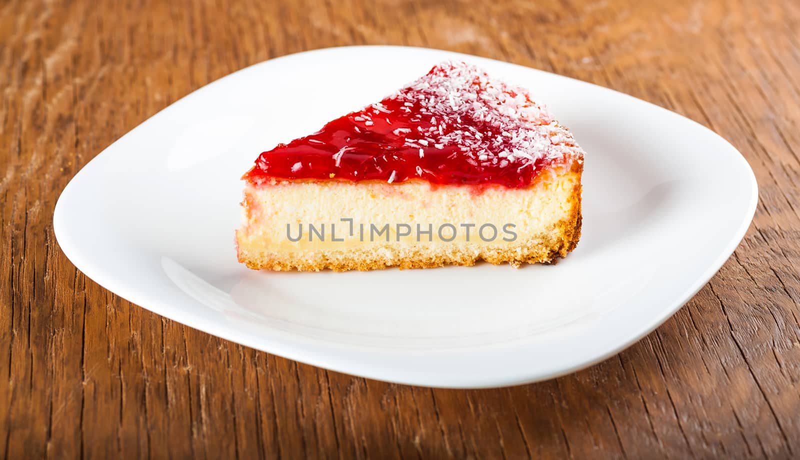piece of cake on a plate on a wooden background