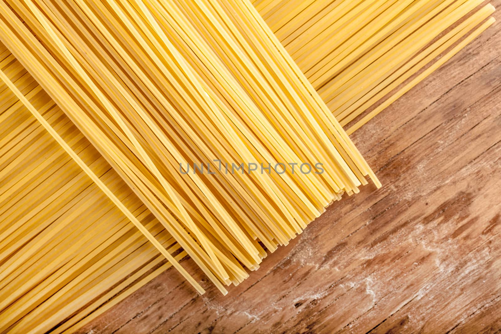 pasta lined up in a row on a wooden background