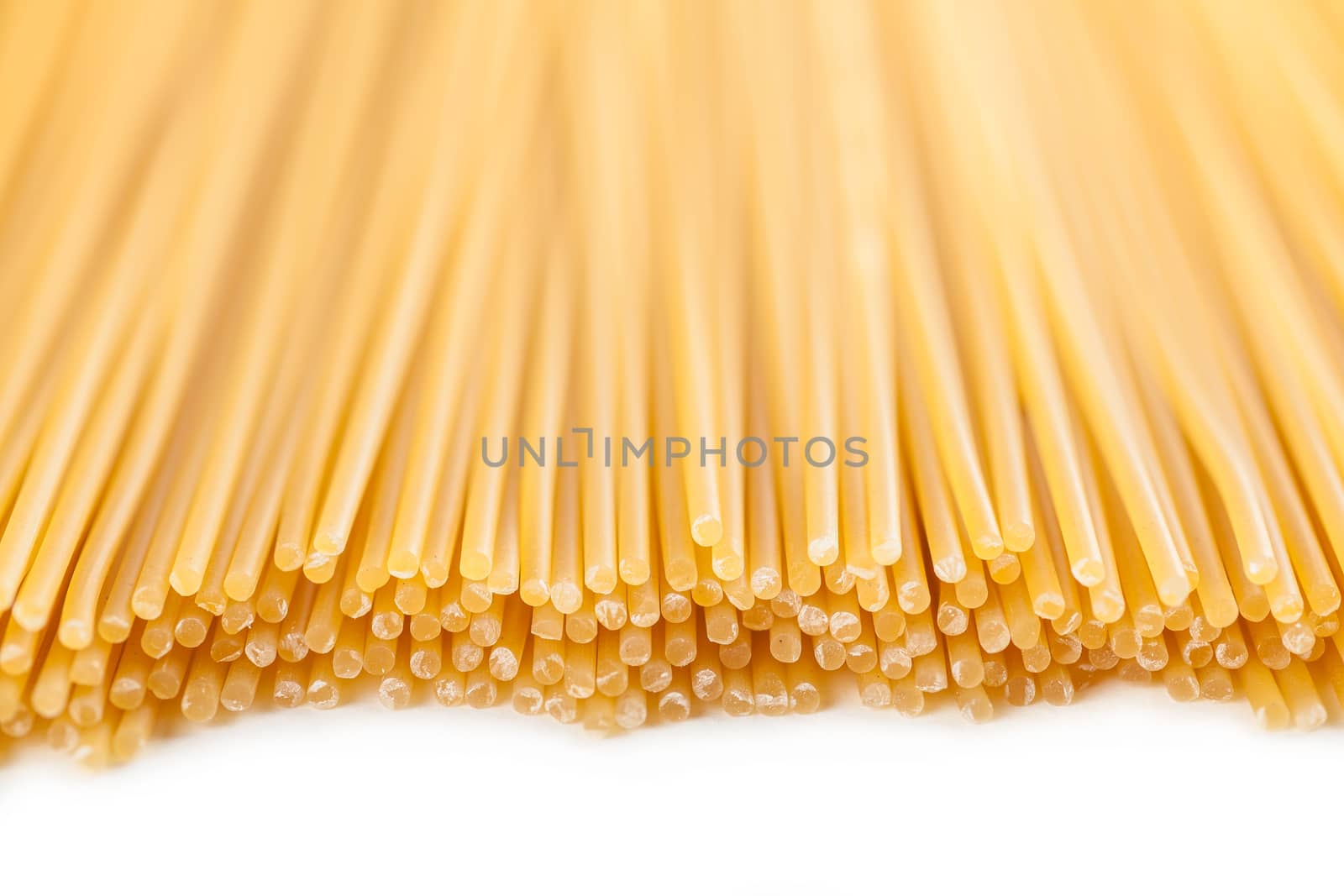 background neatly lined with vertically raw pasta 