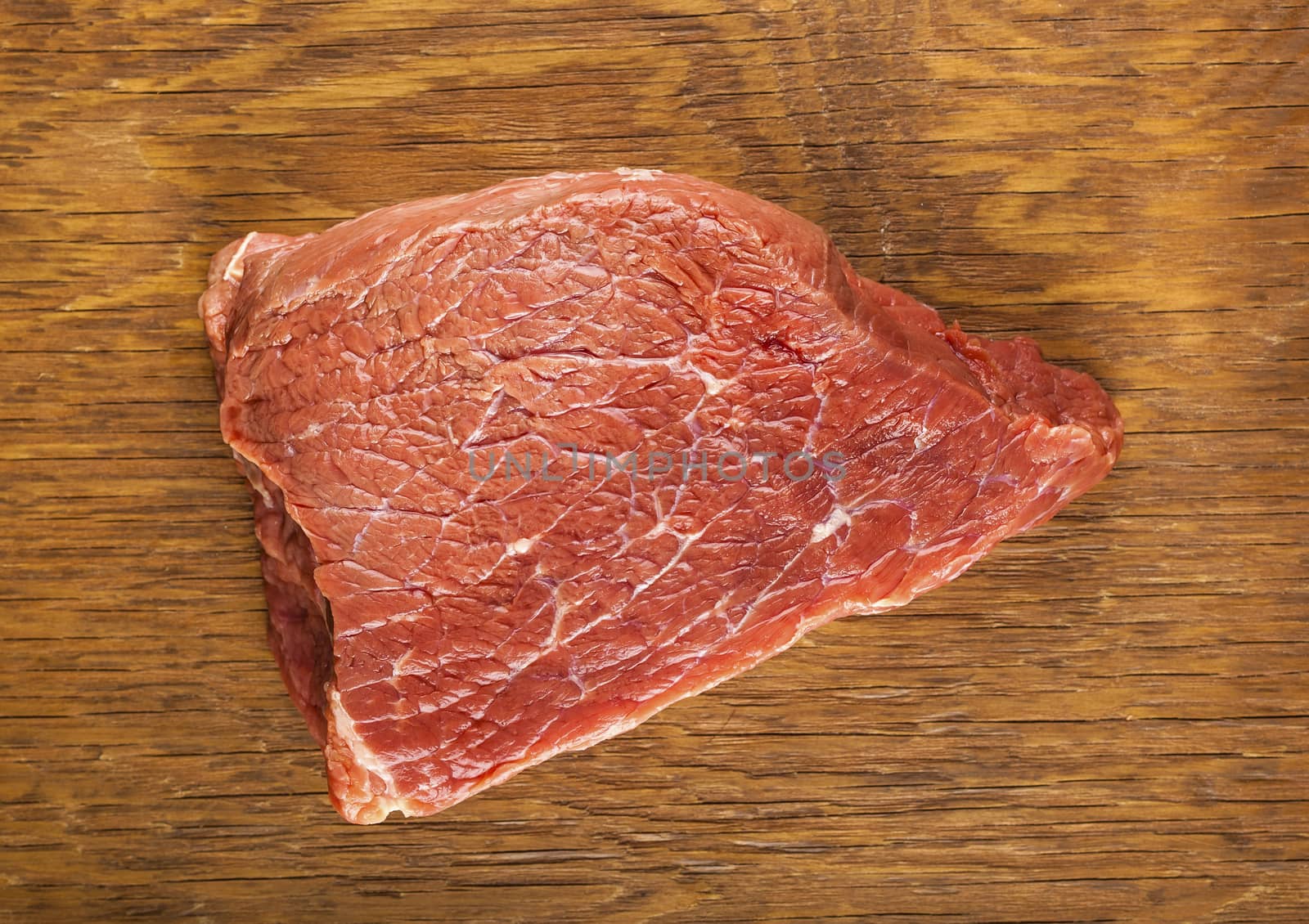 raw fillet of beef on wooden background