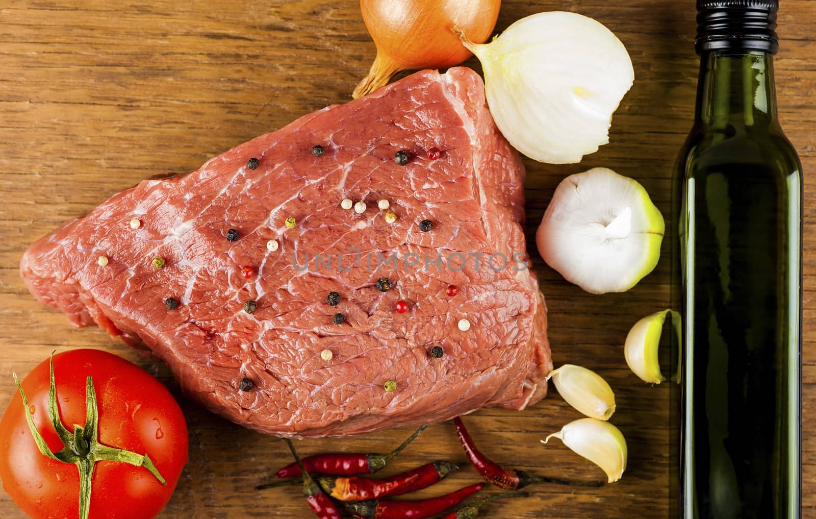 beef fillet with spices on a wooden background
