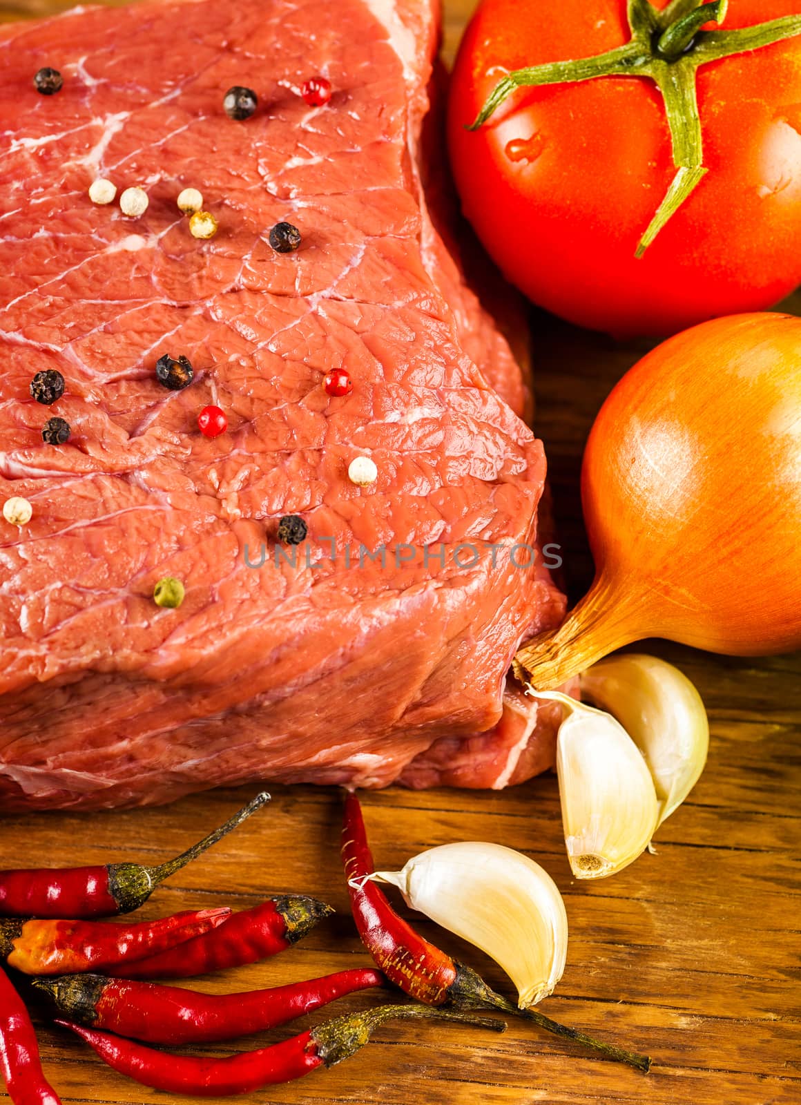 raw beef fillet with spices and vegetables 