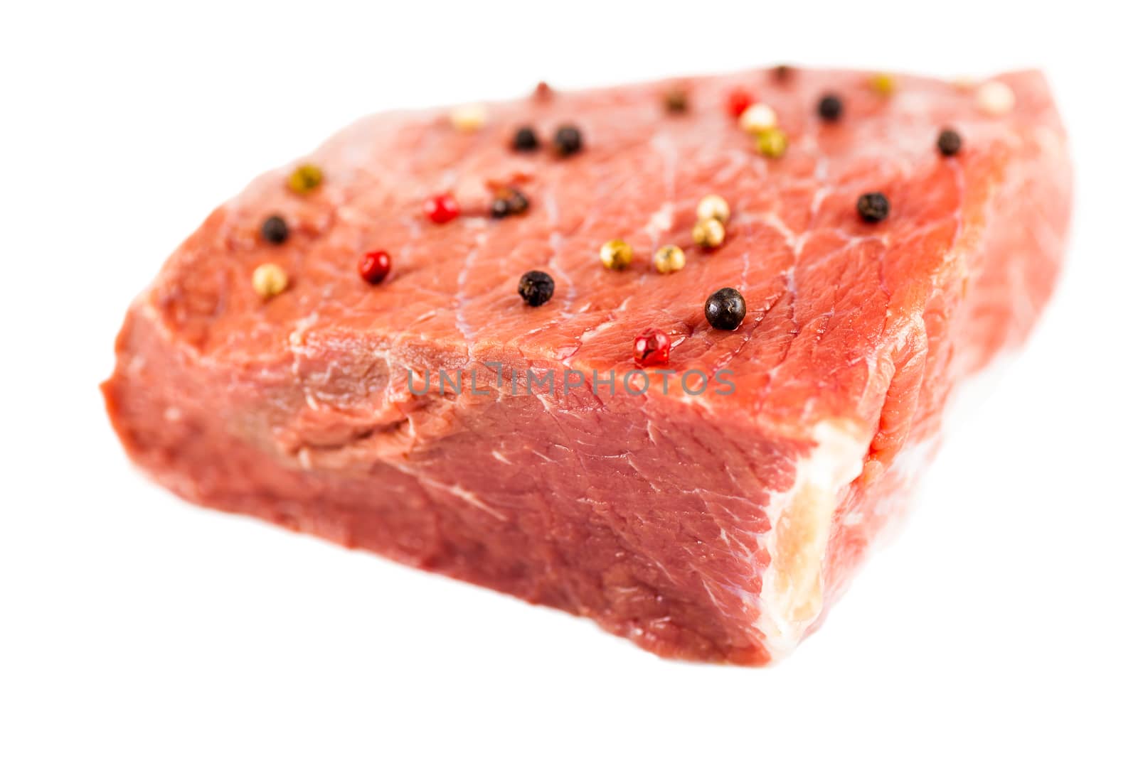 raw beef filet with spices isolated on a white background