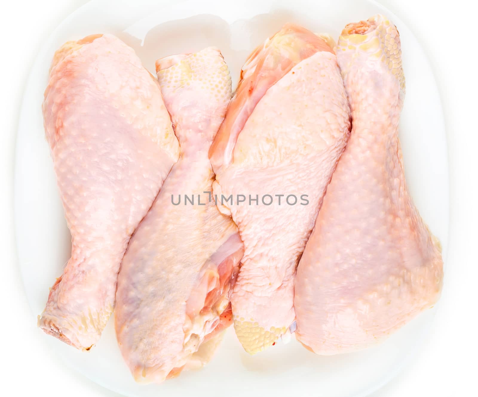 Fresh raw chicken legs on a white background