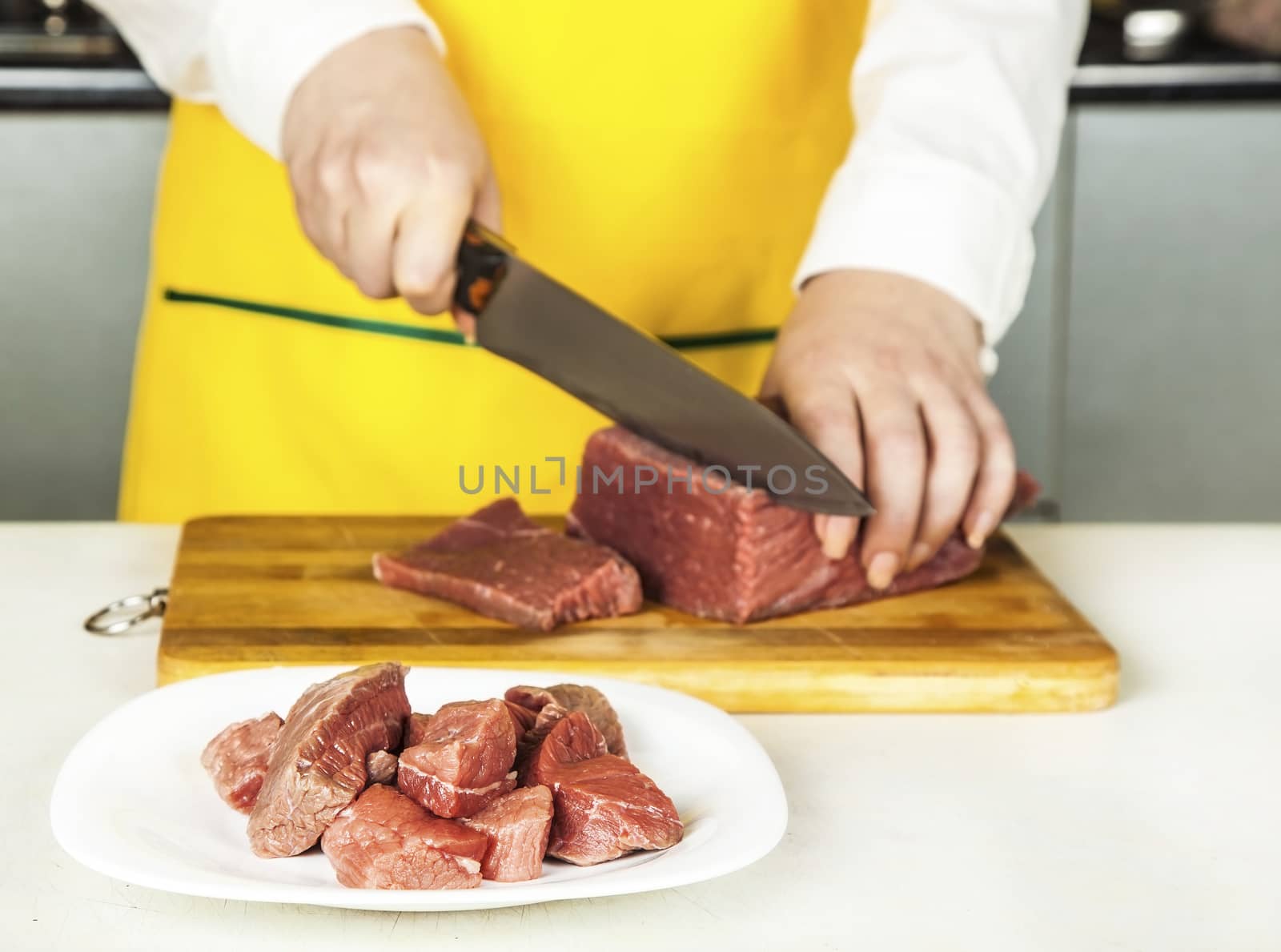 woman cook chopped fresh fillet of beef knife