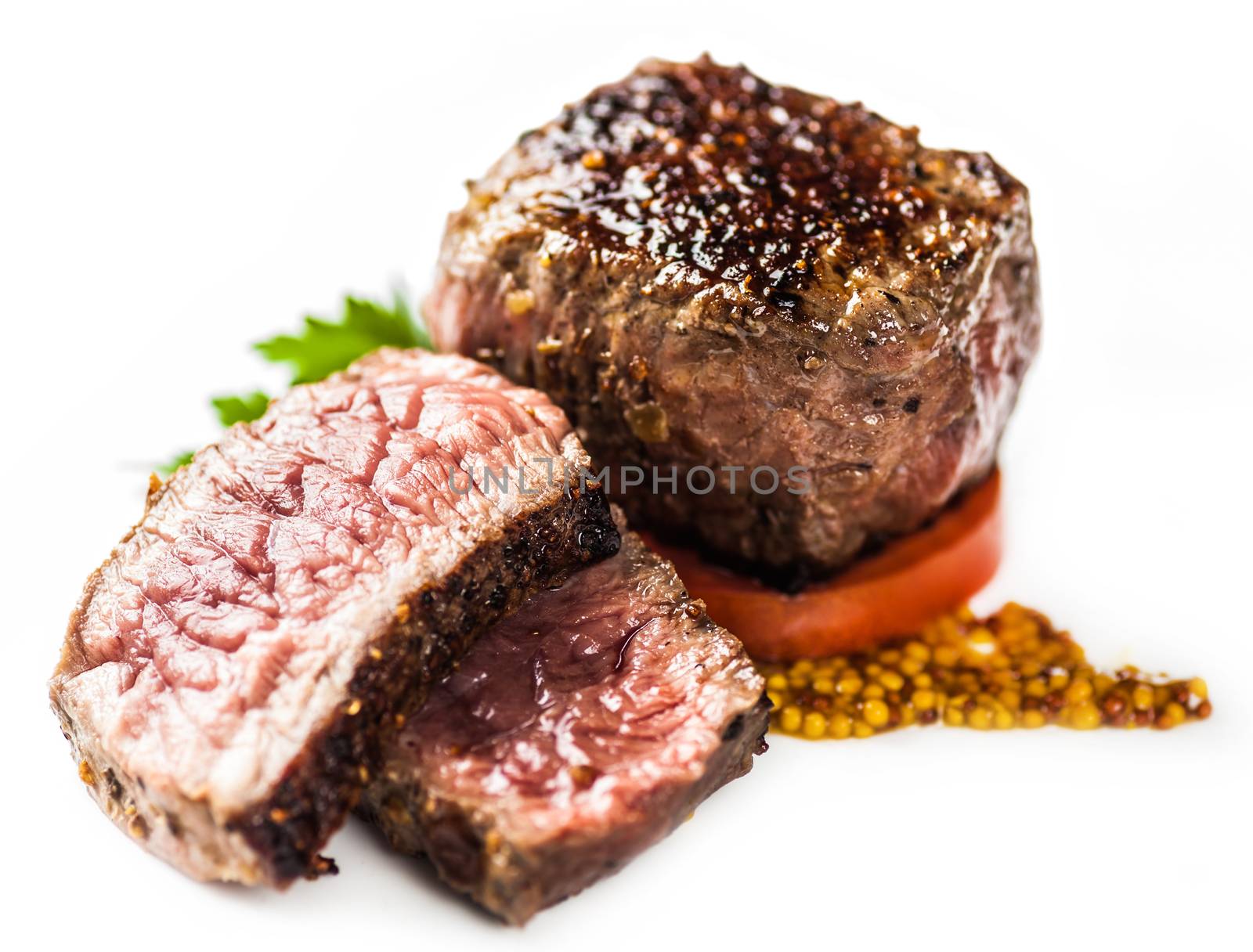 medallion with a slice of tomato sauce and greens on a light background
