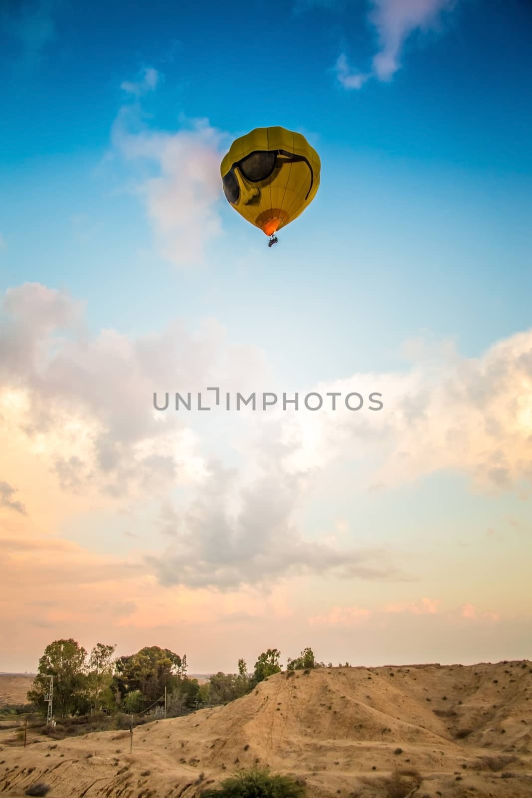 yellow balloon flying high above the earth