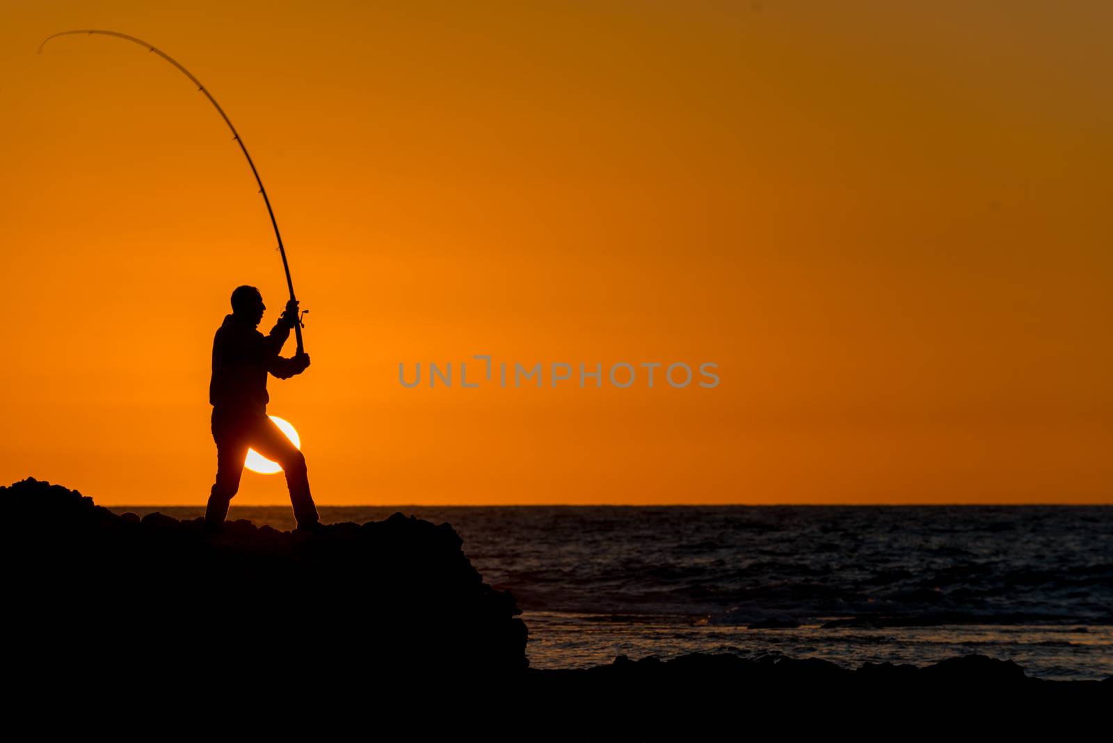 Fisherman catches at dawn, early summer morning