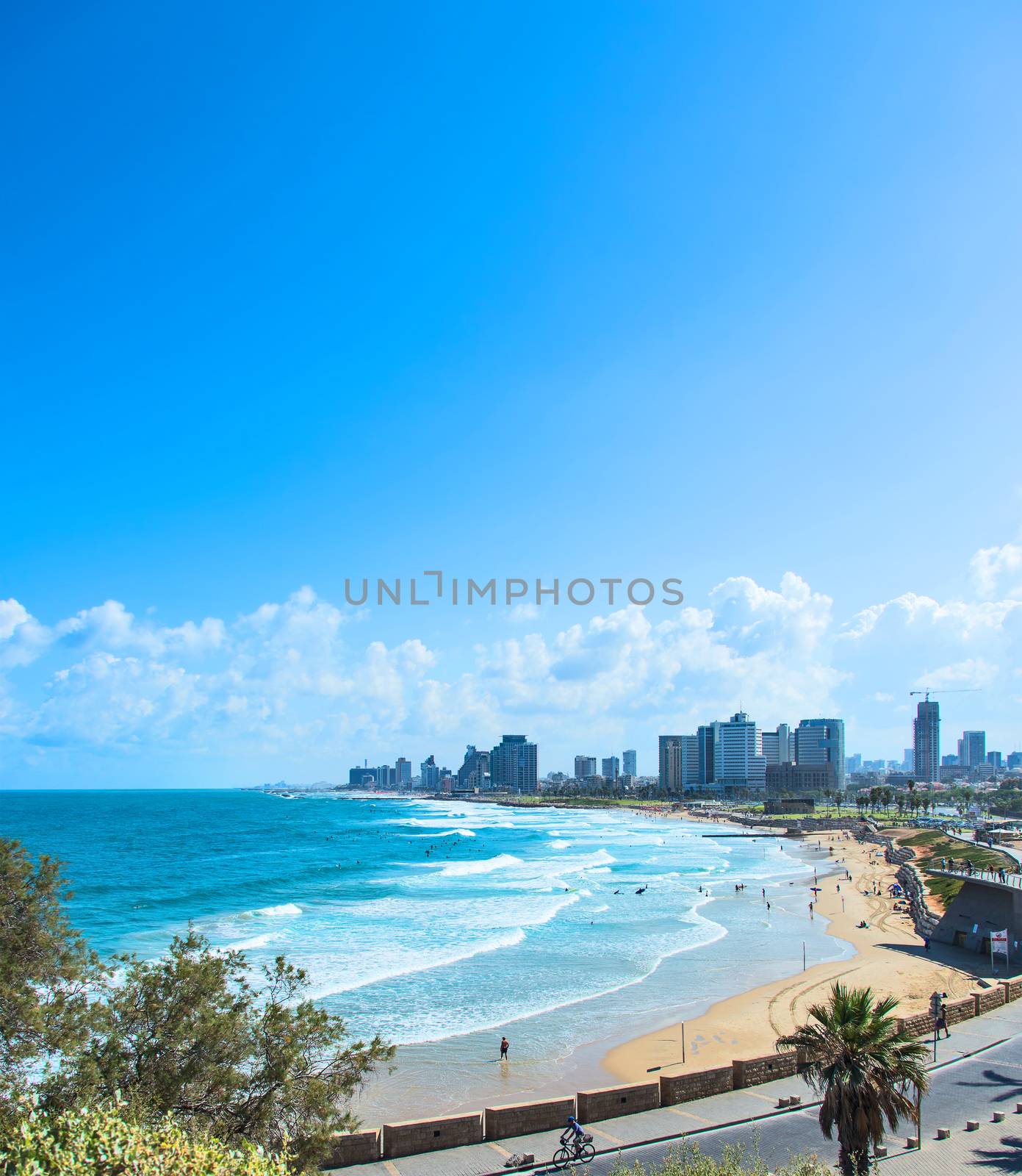  beach with waves on the background of the city