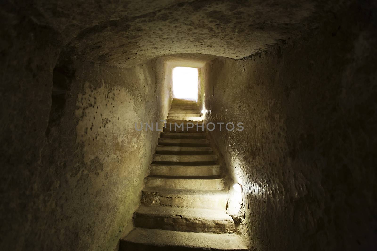 stone narrow passage with stairs leading to the exit