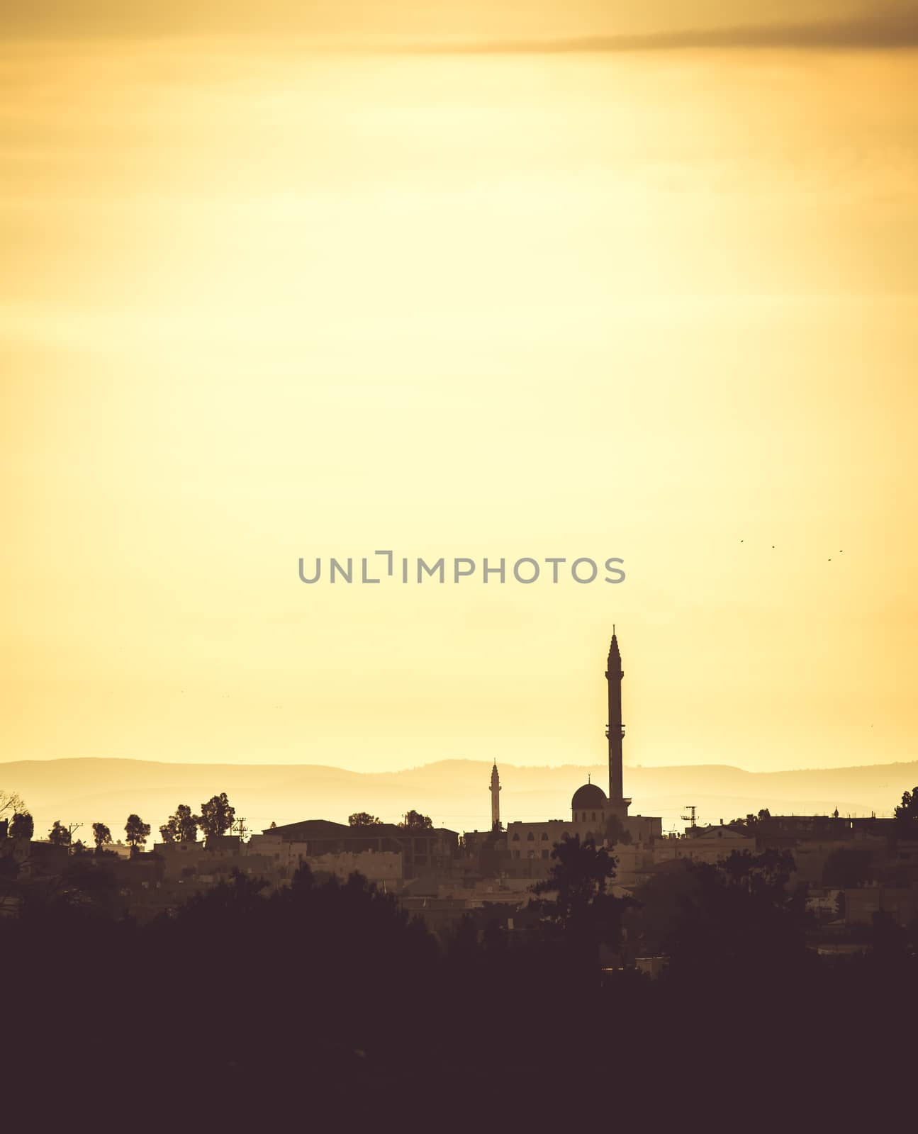 landscape Arab settlements with mosque at sunset