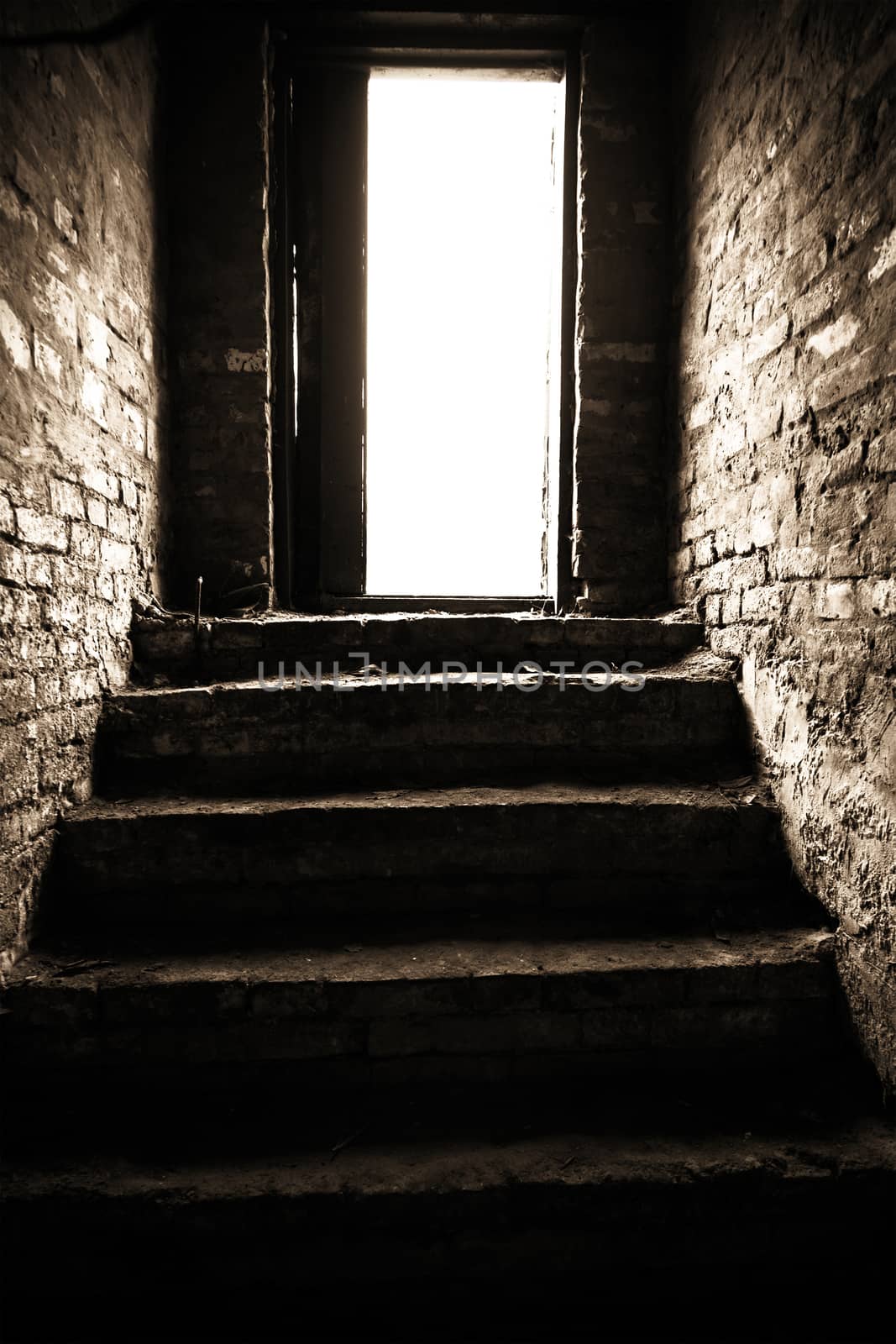 a narrow passage with a stone staircase leading up